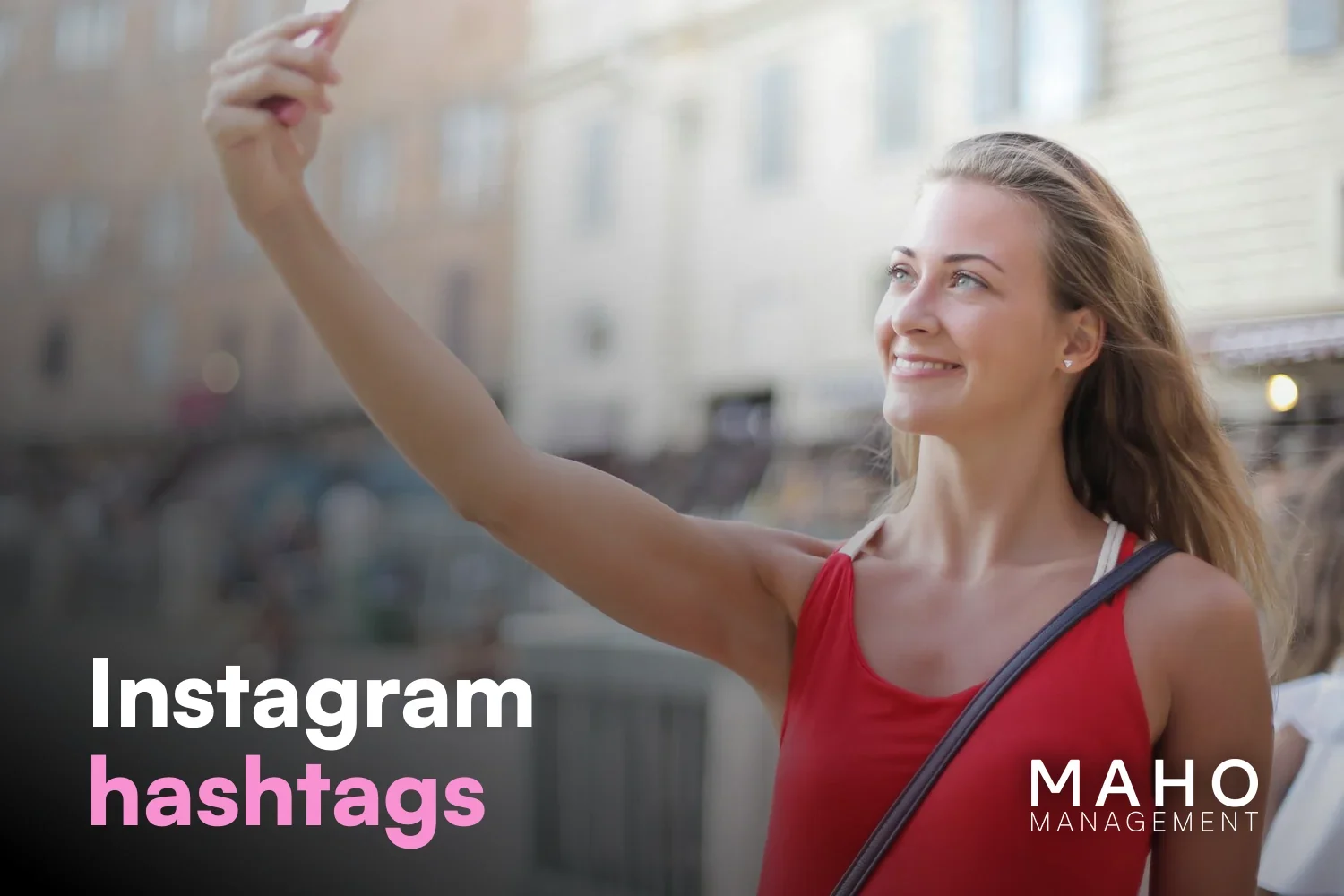 Smiling woman taking a selfie on a city street (best OnlyFans hashtags for Instagram)