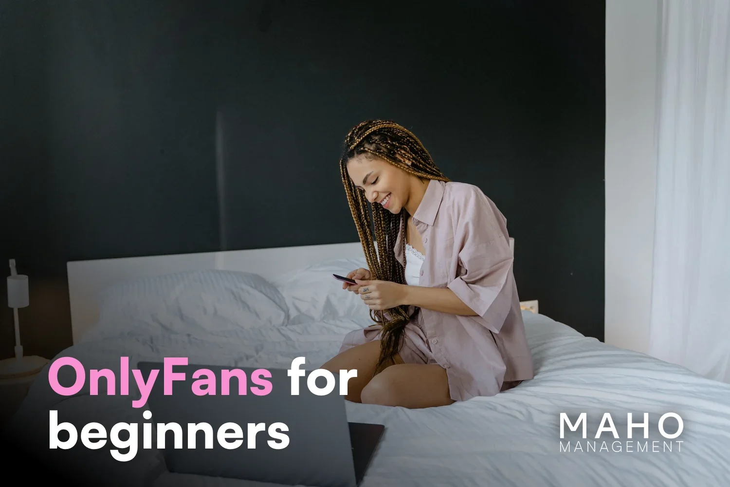 Young creator sitting on a bed with a laptop – first steps on OnlyFans